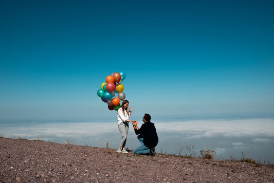 man proposing with balloons