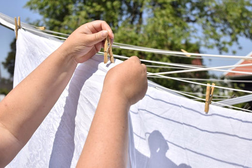 woman-hangs-white-sheets