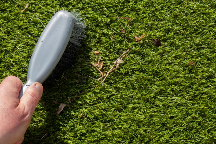 brushing-rubbish-on-greenery