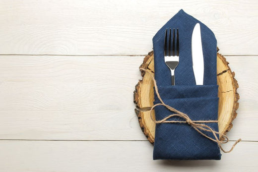 blue cloth napkin with fork and knife