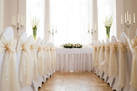 white-chair-covers-with-gold-sash