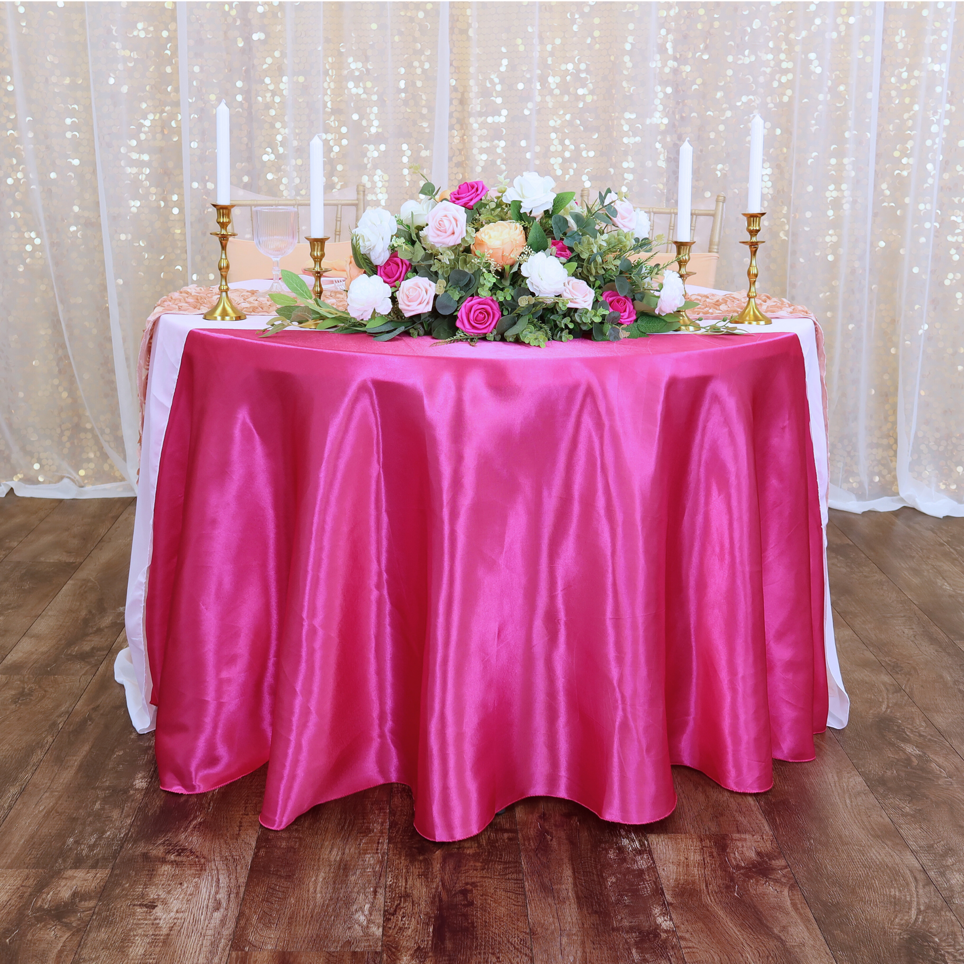 white sheer voile drapes in front of gold large payette sequin drapes behind a fuchsia sweetheart table