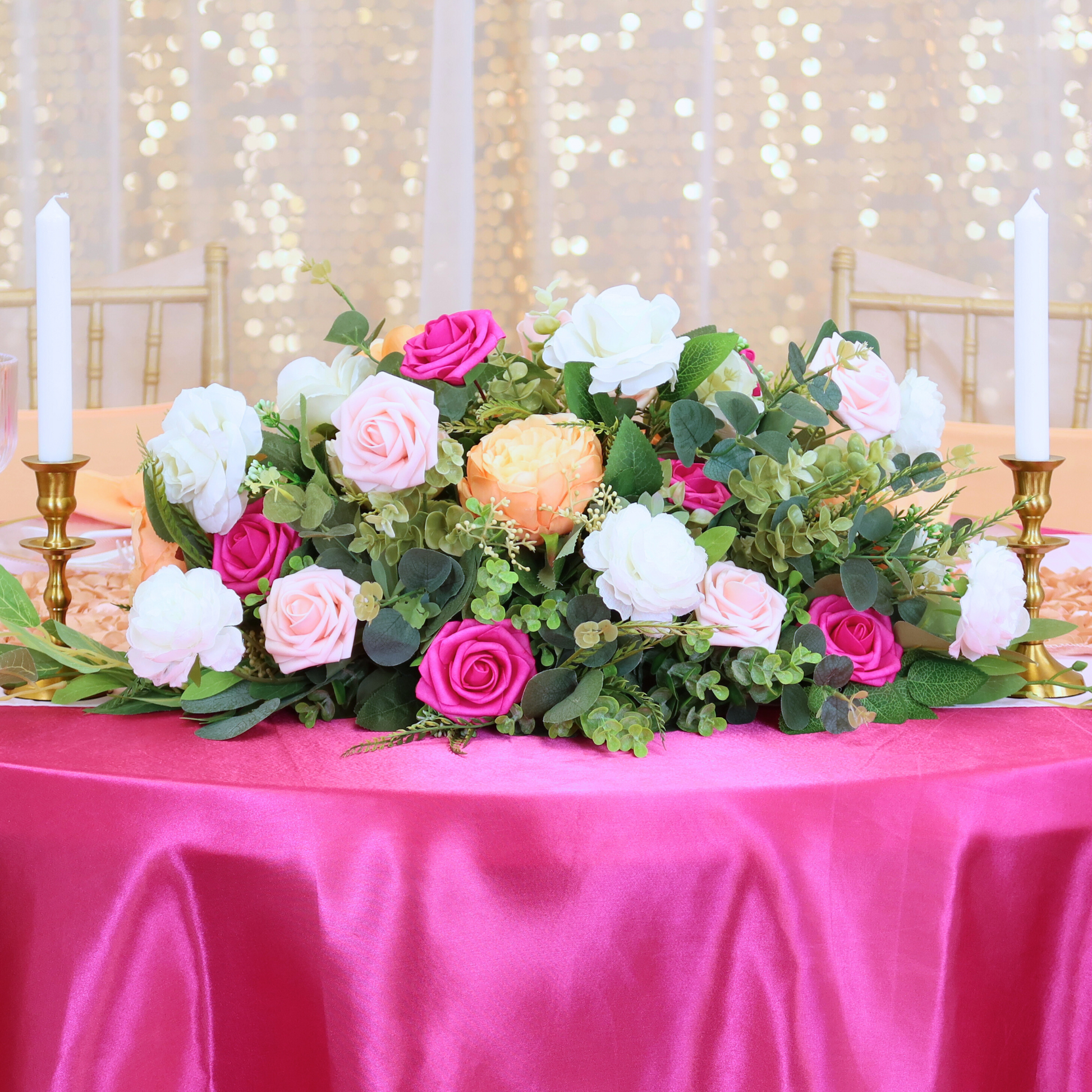 white sheer voile drapes in front of gold large payette sequin drapes behind a fuchsia sweetheart table close up