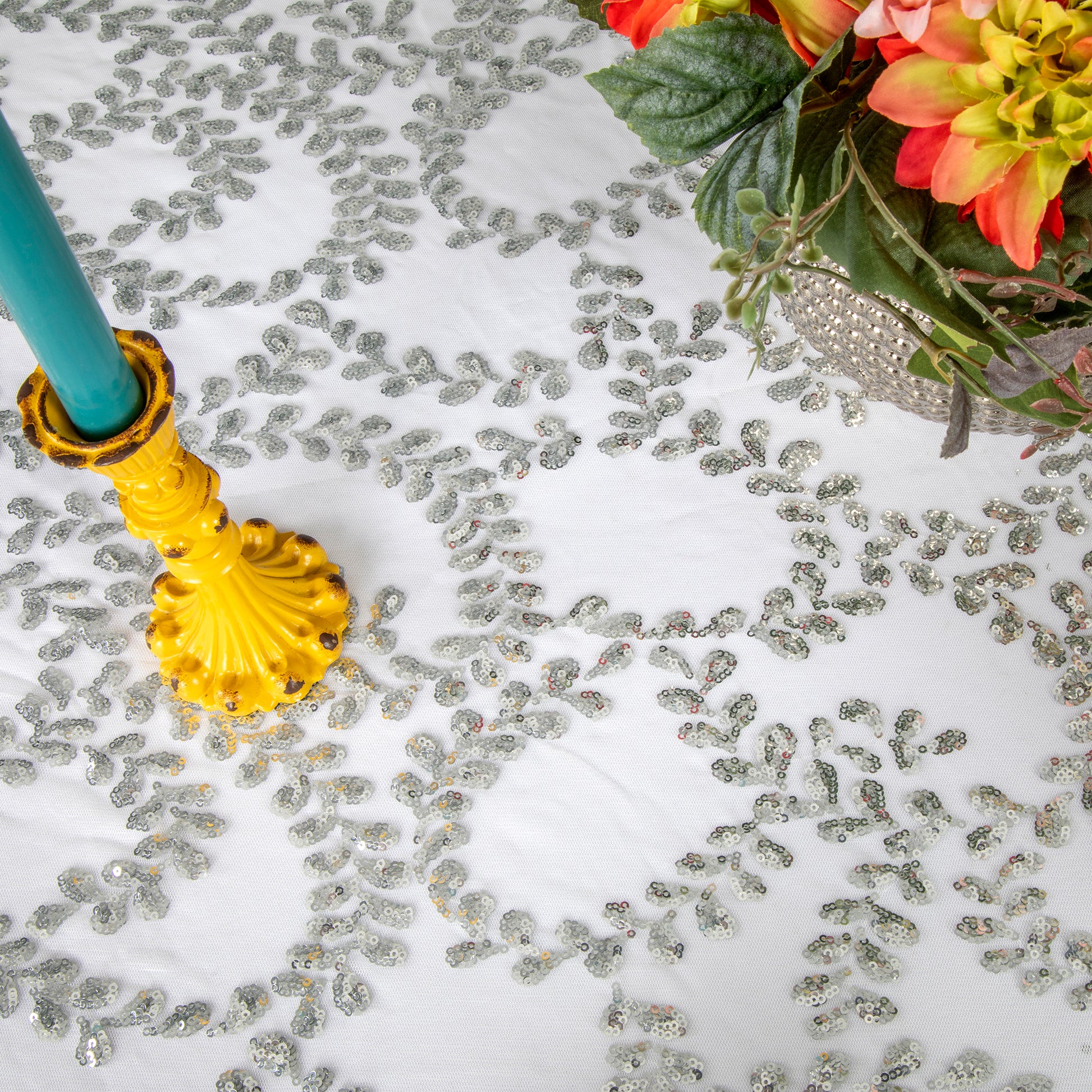 https://www.cvlinens.com/cdn/shop/products/sequin-vine-tablecloth-overlay-round-silver3.jpg?v=1666716605&width=1946